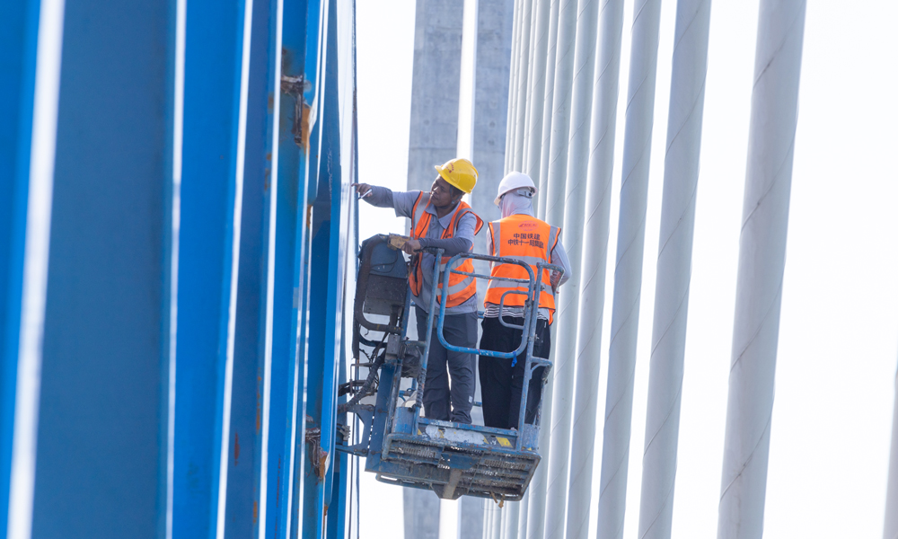 图为施工人员进行钢桁梁焊缝检测。